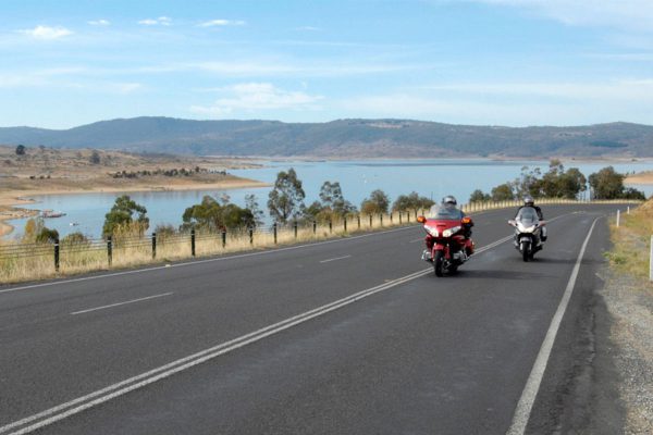 Motorcyclists pass by Lake Jindabyne in the Snowy Ride.